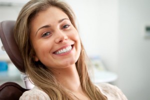 Smiling dentistry patient of Murray UT dentist Dr. Blackwood shows off her tooth crown near Salt Lake City.