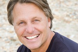 Smiling man shows off the dental implants he had surgically implanted by a Murray UT dentist.