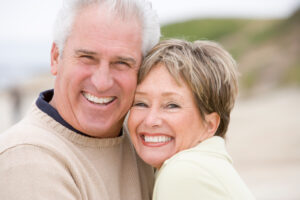 A mature couple smiling after restorative dentistry in Salt Lake City.